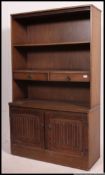 A Jaycee style oak upright dresser cabinet. The base with cupboards having glass cabinets atop.