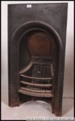 A Victorian cast iron fireplace. Ebonised with inset grill.