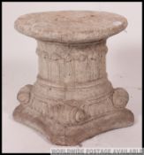 A large stone garden ornament plinth stand of neo-classical design having fabulous carved large