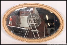 A good quality Edwardian large gilt oval wall mirror.