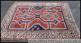 A good Turkish rug with red and blue ground having geometric borders and tassled ends.