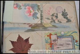 JAPAN; Vintage postcard album, black lacquer boards with silver dragon inlaid to front.