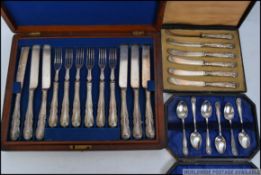 A mahogany cased silver plate canteen of cutlery having inner tray and contents together with a