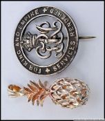 A silver contemporary ladies pineapple necklace pendant together with a silver military pin brooch