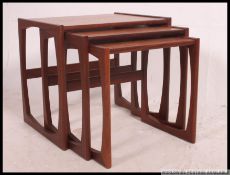 A 1970's retro G-Plan teak wood Kelso pattern nest of tables having chamfered edge shaped supports