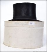 A 20th century gentlemans top hat complete in the original packaging.