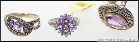 A collection of three boxed silver ( 925 stamped ) amethyst set rings,