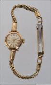 A ladies 9ct / 375 gold vintage Majex 21 jewel Incabloc cocktail dress watch set on snake style