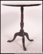 A late 18th century Georgian mahogany circular tilt top occasional table.