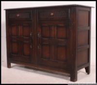 A vintage mid century Ercol dark Elm dresser base,