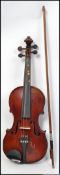 An early 20th century wooden cased students violin with Medio Fino to inner