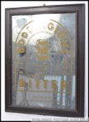A retro framed advertising mirror, having an oak frame,