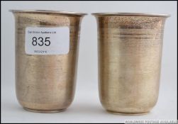 2 silver ( tested ) 20th century stirrup cups being engine turned having illegible marks to the
