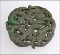 A large detailed jade roundel decorated with birds and dragons.