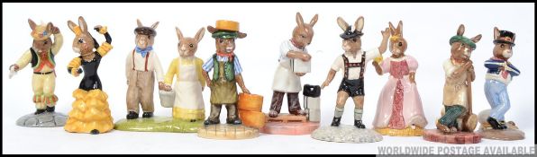 A group of 9 Royal Doulton Bunnykins to include Jack and Jill , Cinderella , Kiln Placer ,