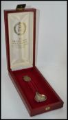A silver hallmarked commemorative spoon in the original presentation case.