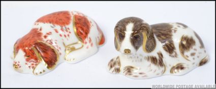 A pair of Royal Crown Derby paperweights Scruff and Puppy both with gold stoppers.
