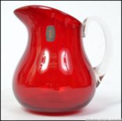 An original retro mid century Whitefriars cranberry glass pitcher jug with clear glass handle,