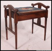 An Edwardian mahogany stencil painted inlaid piano stool with blue tapestry upholstered seat with