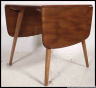 An Ercol Windsor pattern drop leaf dining table.