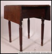 A Victorian mahogany pembroke dining table raised on reeded tapering legs with drop leaves on fly