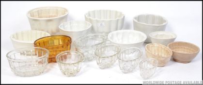 A large collection of Victorian and later jelly moulds to include several ceramic and glass moulds,