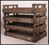 A group of vintage wooden apple / fruit transportation crates along with a metal wire work bread