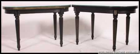 A pair of Regency revival ebonised and parcel gilt side tables.
