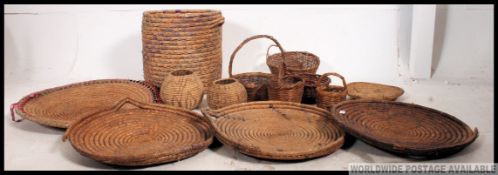 A good collection of vintage whicker baskets and trays,