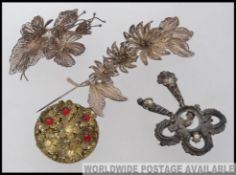 A collection of vintage costume jewellery brooches of filigree workings in silver.