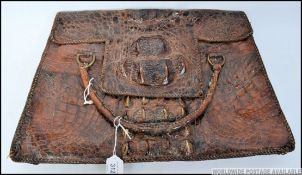 A vintage alligator leather ladies handbag, having lift up flap to reveal lined interior.