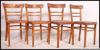 A set of 4 retro 1950's kitchenette utility style chairs having vinyl padded seats with railed