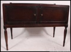 An Edwardian mahogany twin door washstand side / hall cabinet raised on turned legs with double