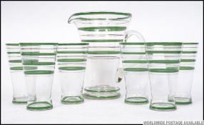 A stunning retro mid century lemonade set comprising green banded glasses and matching pitcher jug.
