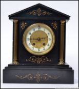 A late 19th century Victorian column mantle clock having gilt decoration,