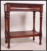 A Victorian flame mahogany side table raised on turned legs with a serpentine fronted single drawer