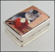 A 925 white metal silver and enamel pill box depicting a kitten with a ball of wool.