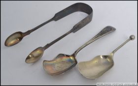 A hallmarked set of silver sugar tongs along with two non matching silver metal tea caddies
