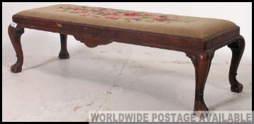A believed 19th century walnut and tapestry upholstered Queen Anne style long foot stool being
