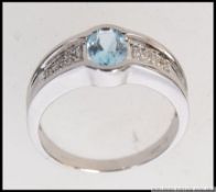 A modern 9ct white gold ( stamped 375 ) dress ring having a single set polished stone to centre RS