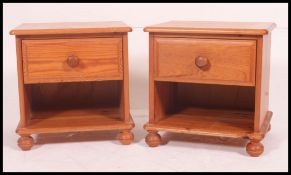 A good quality contemporary pine pair of bedside cabinets having single drawers with knob handles