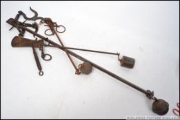 A pair of 19th century fireside potjacks / game scales made of cast iron complete with the ball