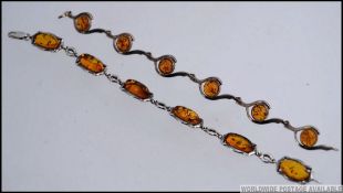 A beautiful pair of ladies silver 925 and cabochon amber set bracelets having clasp locks