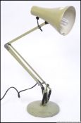 A mid century light green Herbert Terry anglepoise lamp with circular base and pendant shade