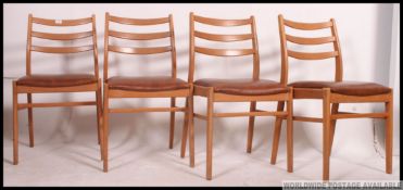 A set of 4 1960's light teak wood retro dining chairs.
