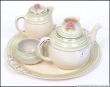 A 1930's Art Deco tea ceramic tea for one set. Comprising, tray, teapot, cup, sugar and creamer.