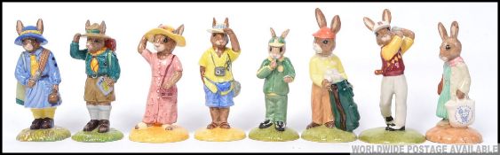 A group of 8 Royal Doulton Bunnykins to include Shopper , Golfer , Caddie , Stop Watch , Boy Scout ,