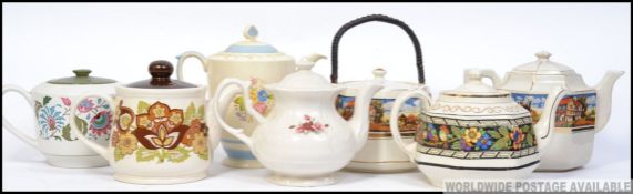 A collection of teapots to include a mat
