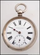 A silver pocket watch being open faced w