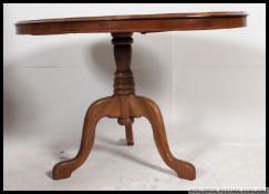 A part Victorian walnut tilt top loo / b